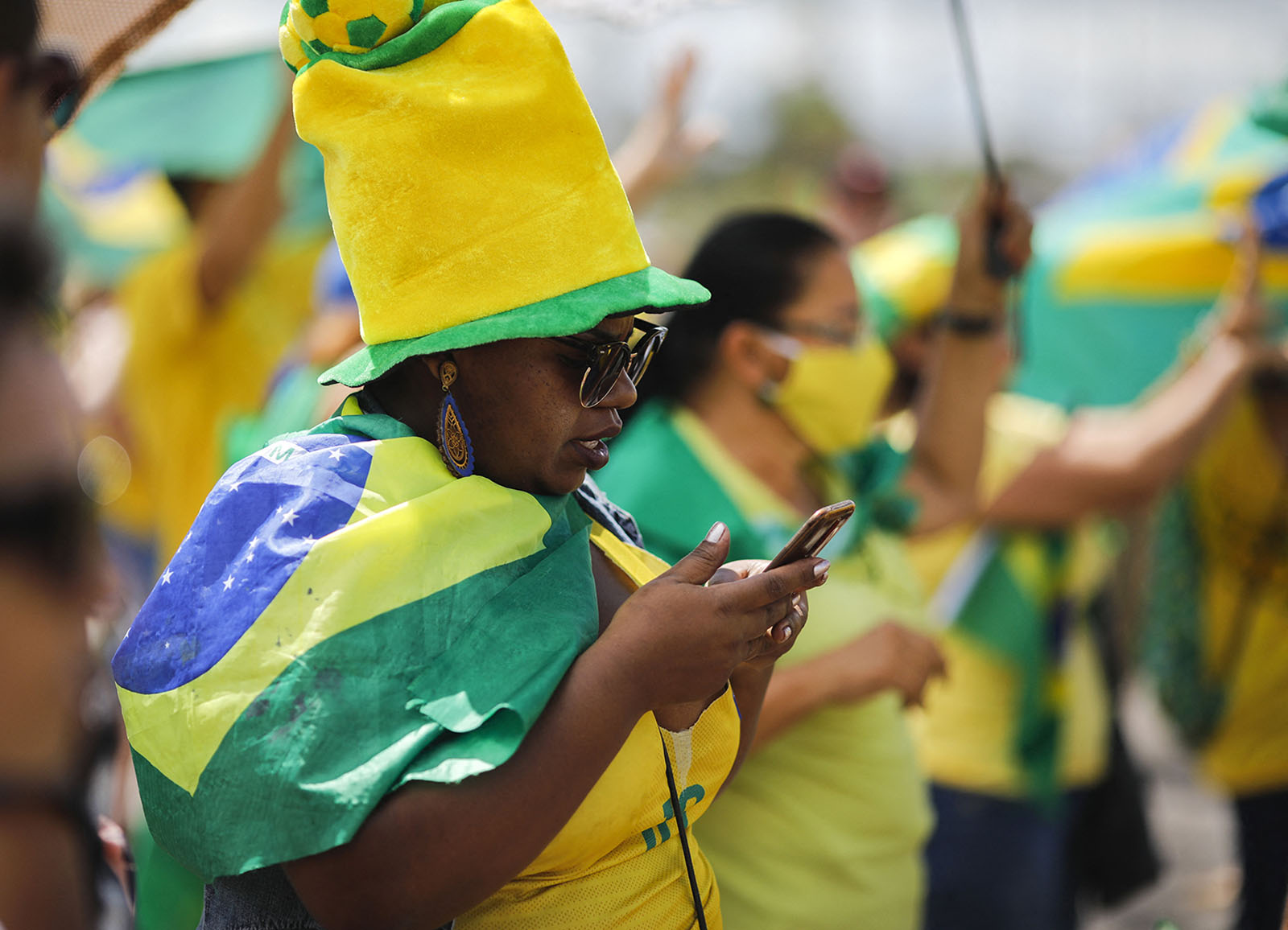 Une partisane de Jair Bolsonaro sur son téléphone durant une manifestation contre les restrictions liées à la Covid.